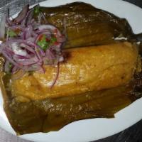 Tamales · Peruvian tamales made with mote, acompanied by their onion salad.