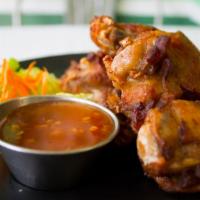 Chicken Wing · Deep-fried marinated chicken wings served with sweet chili sauce.
