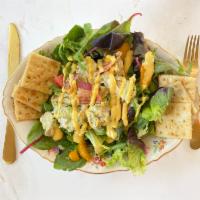 Chicken Avocado Salad · Scoop of chicken avocado salad on a bed of lettuce. Served with crackers. 

