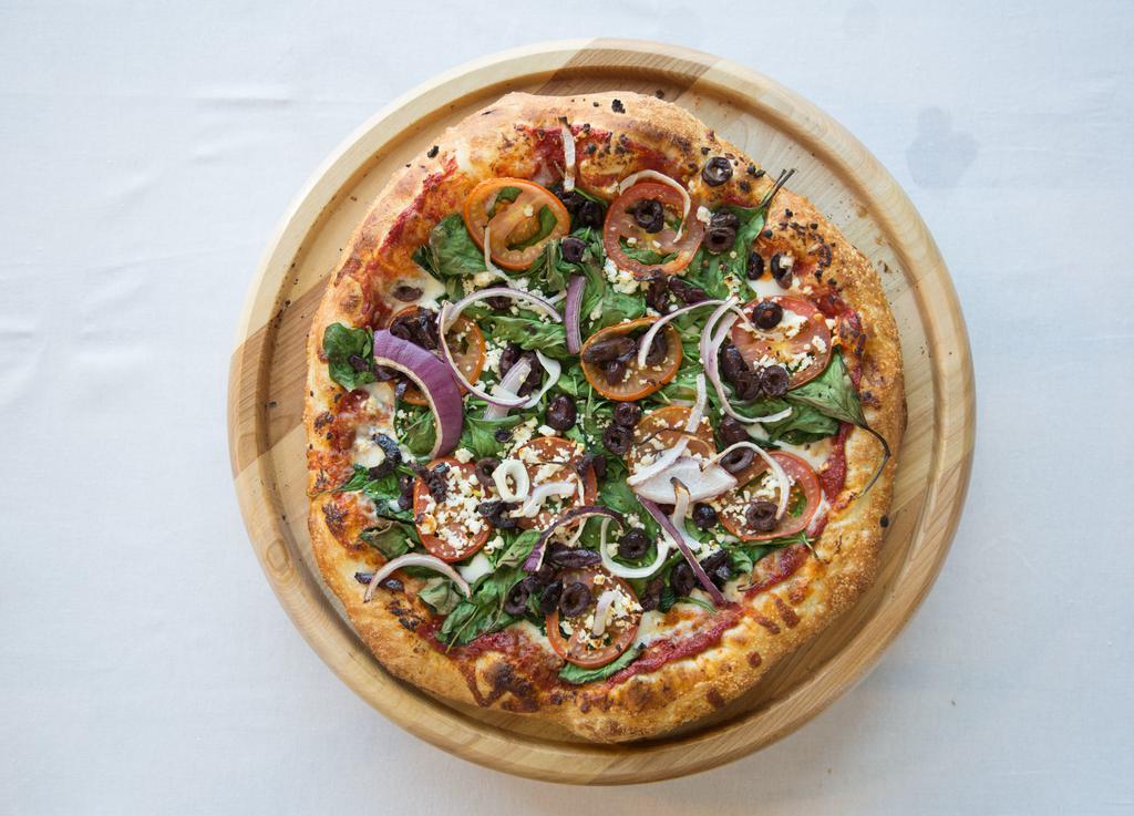 The Greek Pizza · Mozzarella cheese, Kalamata olives, spinach, tomatoes, red onion, feta, red or creamy garlic sauce. Vegetarian.