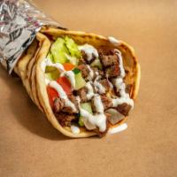 Grilled Lamb Gyro · Grilled lamb served on pita with choice of salad and any of shahs sauces.