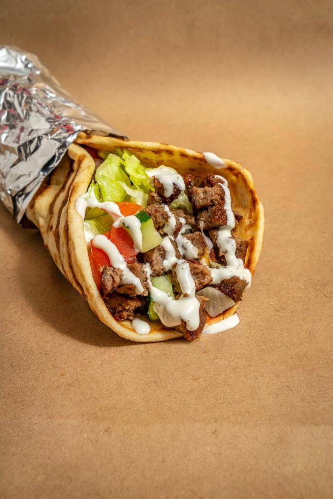Grilled Lamb Gyro · Grilled lamb served on pita with choice of salad and any of shahs sauces.