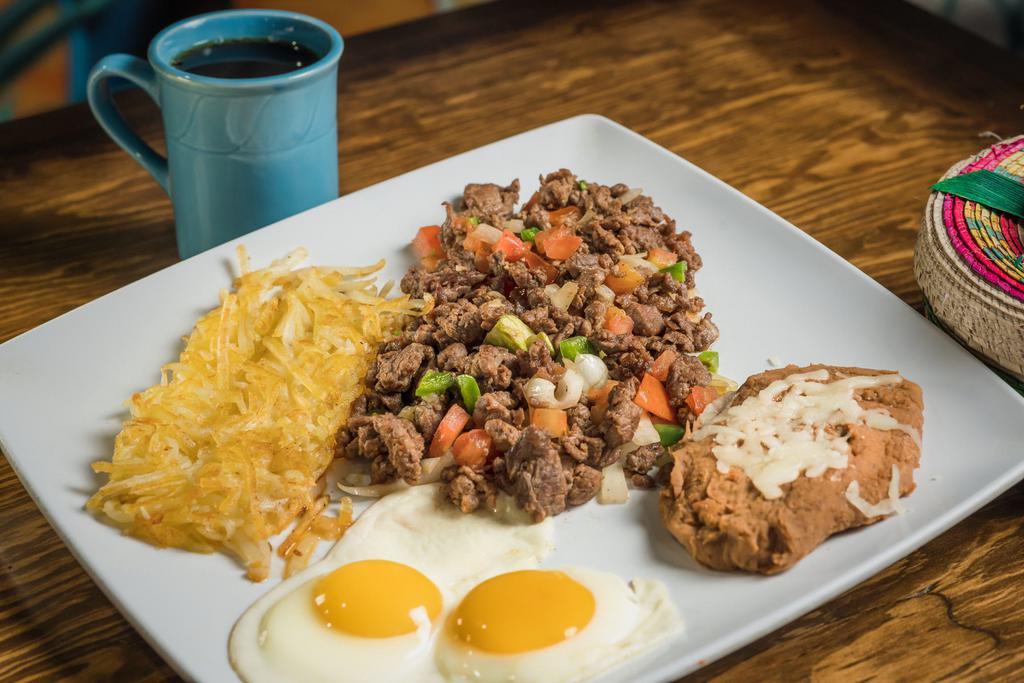 Steak Ranchero Breakfast · Strips of steak combined with peppers, onions, tomato and 2 eggs. Served with hash-browns and beans.