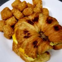 Croissant Breakfast Sandwich · Scramble eggs and cheddar cheese, choice of bacon, ham or sausage.