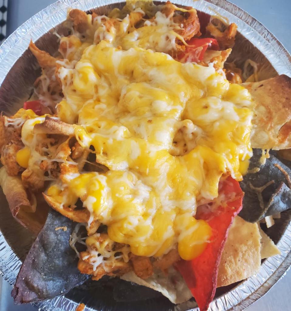 Chicken nachos.  · Sour cream and guacamole on the side