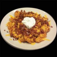 Loaded Waffle Fries · Top our traditional waffle fries with cheddar cheese, loads of bacon, sour cream and jalapen...