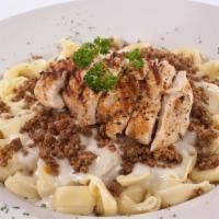 Chicken and Sausage Tortellini · Cheese filled tortellini topped with seasoned grilled chicken and Italian sausage, served wi...