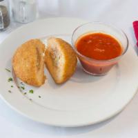 Large Rice Ball · Stuffed with ground beef, peas, mozzarella and grated cheese. 