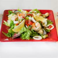 Seafood Salad · Scallops, shrimp, calamari, celery, red onions, red peppers served with lemon dressing. 