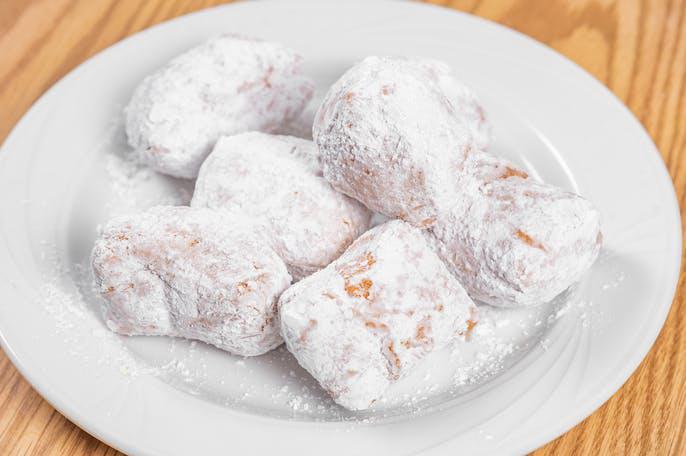 Zeppoles · Deep fried dough balls. Served with powdered sugar.