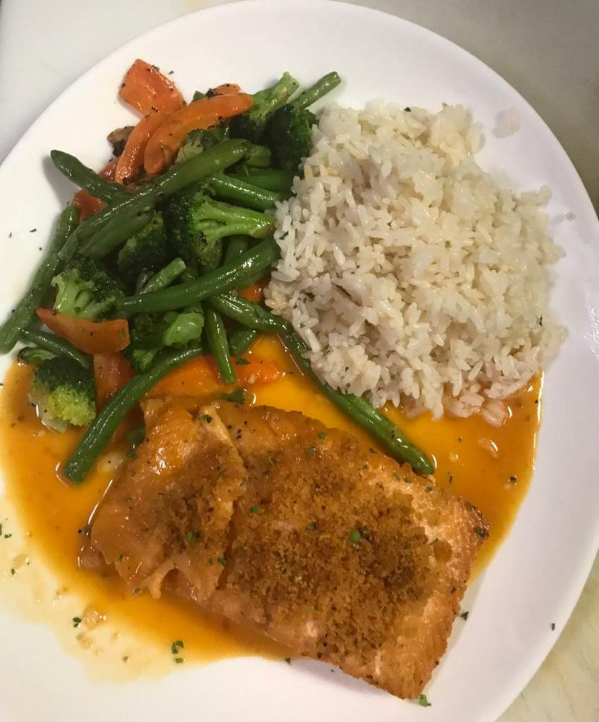Salmon Oreganata Dish · Broiled salmon filet topped with herbs and bread crumbs in lemon white wine sauce. Served with rice and mixed