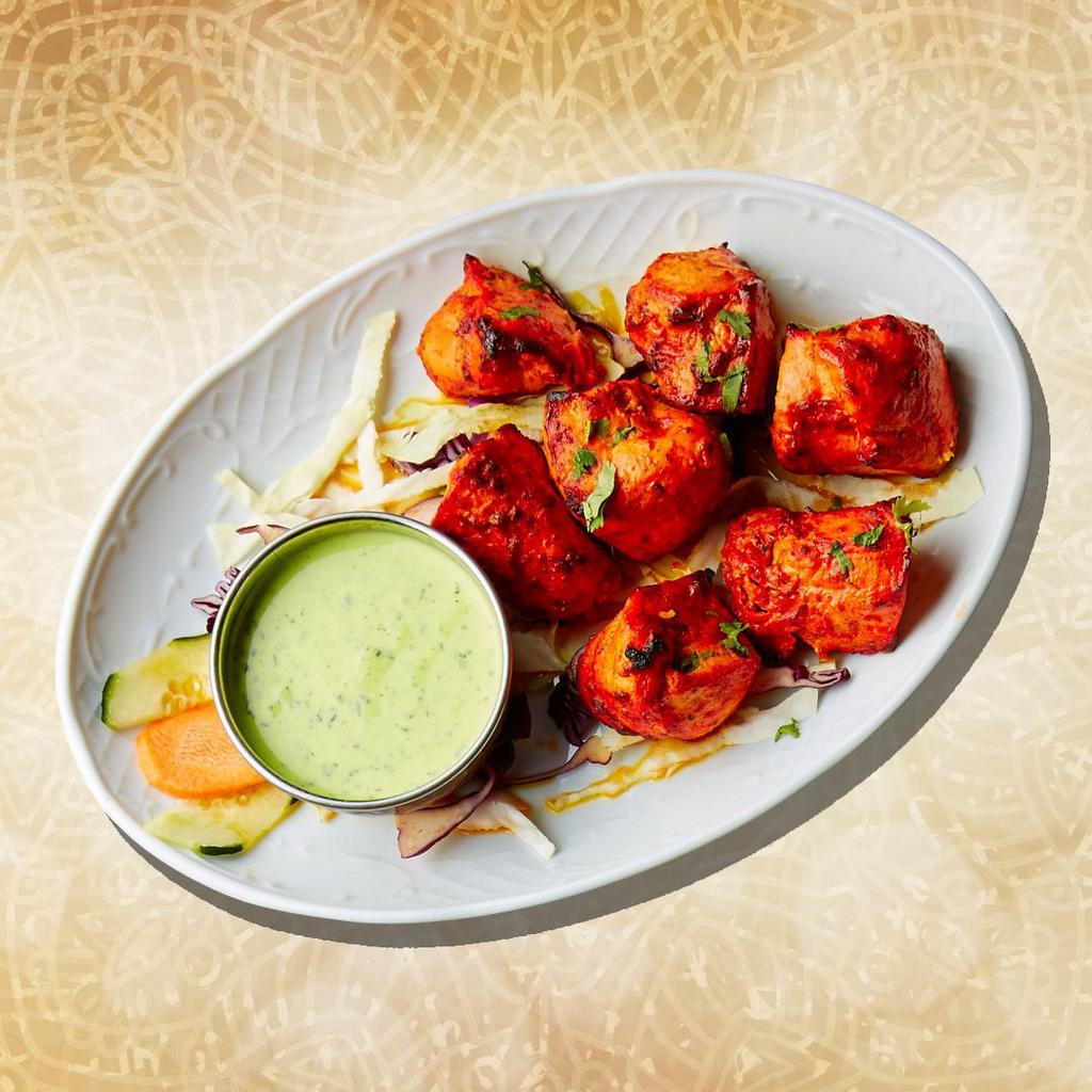 Char Grilled Chicken Tikka (6Pcs) · Tender chicken chunks seasoned in a yogurt tandoori marinade, skewered and grilled in a traditional coal oven
