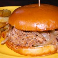 Pulled Pork Sandwich · Opal’s smoked pulled pork with wicked sauce served on a bun with pickles and caramelized oni...