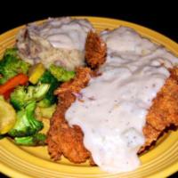 Chicken Fried Chicken Plate · Our tenderized chicken breast hand battered topped with cream gravy, served with garlic mash...