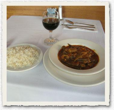 Bamia B'ziat · Fresh okra cooked in a tomato sauce made with garlic and onions, served with rice. 