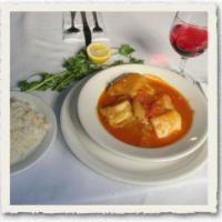 Eggplant Stew · Eggplant stewed with potatoes and onions in tomato sauce served with rice. 
