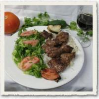 Shish Kabob · Charcoal broiled lamb and vegetables served with rice and salad. 