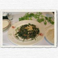 Sbanegh · Sauteed spinach, ground lamb, and pine nuts, served with rice and yogurt. 