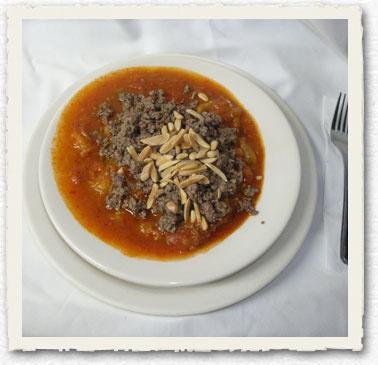 Minazli · Sauteed eggplant cooked in a tomato sauce, and topped with ground lamb and pine nuts. Served with rice. 