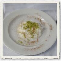 Riz B'halib · Rice pudding. Made with rose water, topped with nuts. 