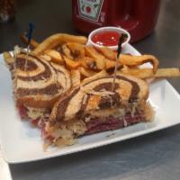 Reuben Sandwich · Corned beef thinly sliced and served on rye bread with Swiss cheese, sauerkraut and Russian ...