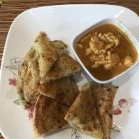 Chicken Roti Curry · Pan fried roti with a side of chicken kari curry.