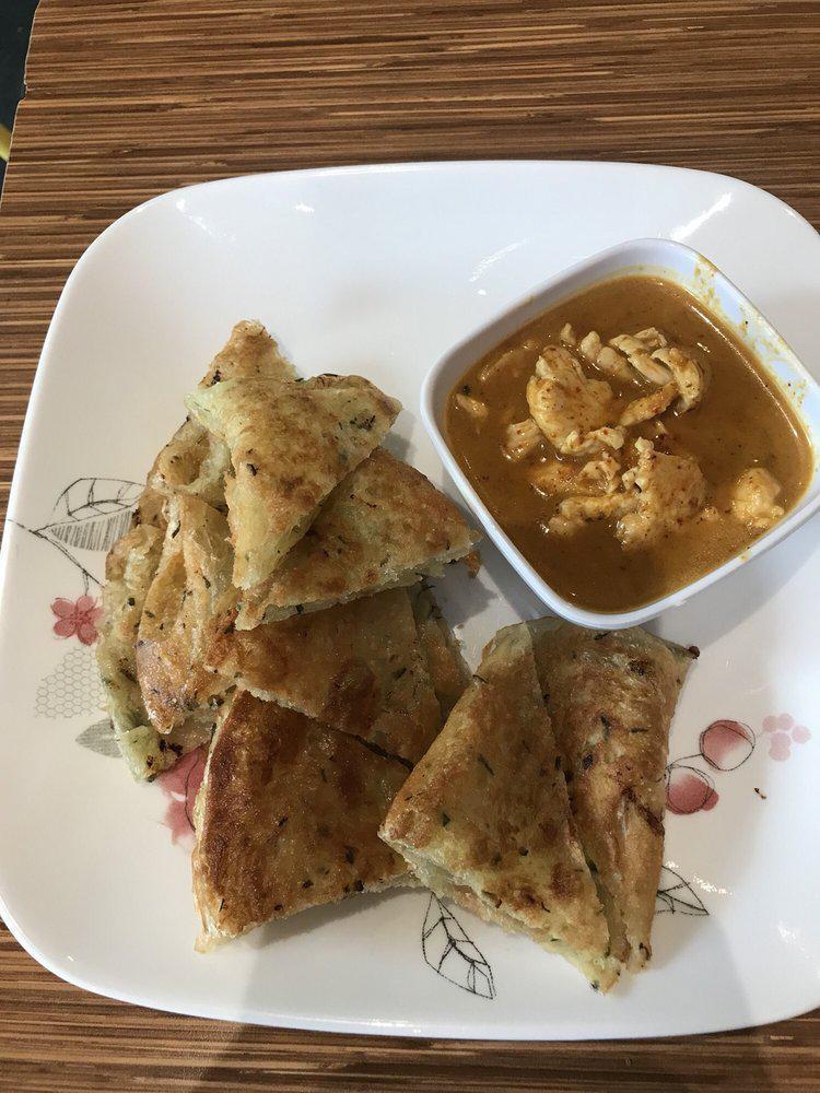 Chicken Roti Curry · Pan fried roti with a side of chicken kari curry.