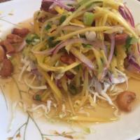 Mango Salad · Shredded mango, onion and scallion topped with cashew nut and mixed with a lime juice dressi...