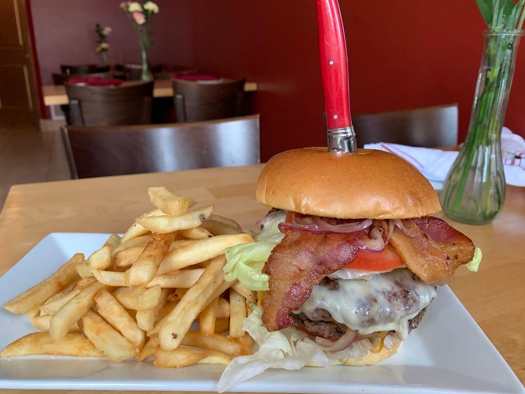 Izzy's Burger Dinner · Two 6 oz. patties, grilled onions, American and cheddar cheese bacon, lettuce and tomatoes, chipotle mayo brioche bun, french fries.