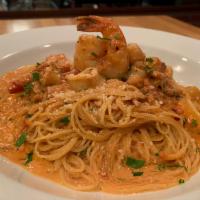 Seafood Paraiso Dinner · Scallops, shrimp, squid, basil brush sauce over angel hair pasta.