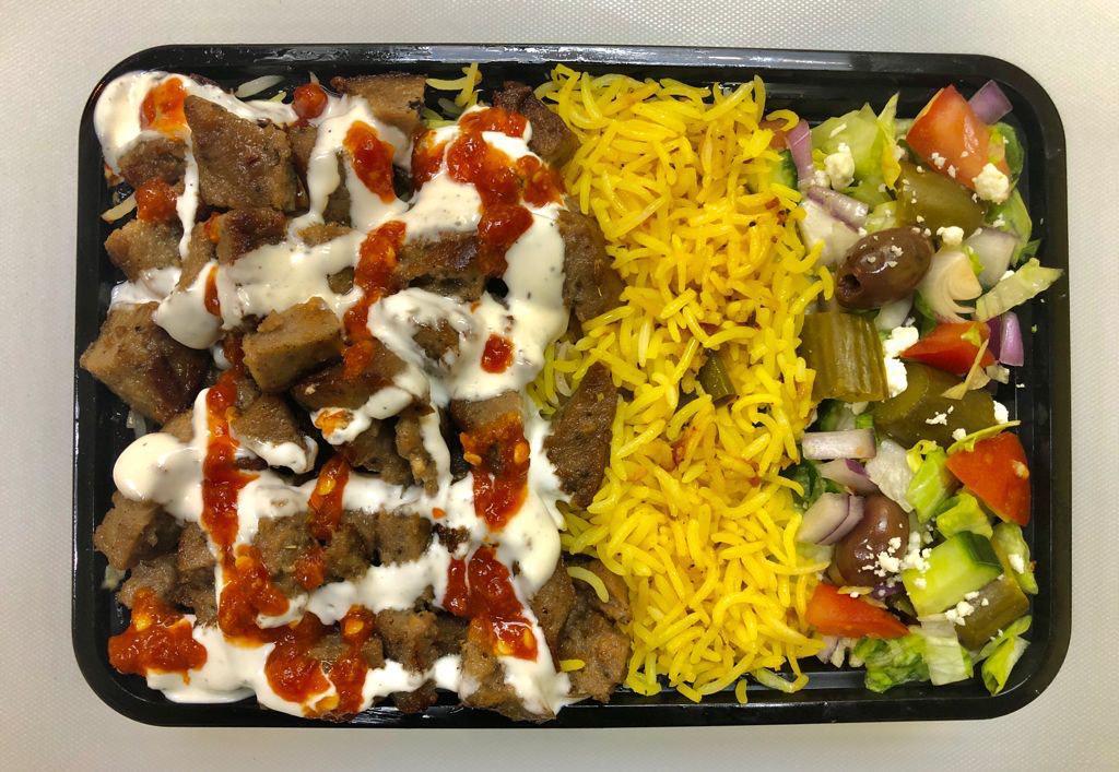 3. Lamb Gyro over Spicy Rice · Chopped tender lean gyro style lamb meat ( Infused  with 30% beef ) over spicy rice ,side of salad( Lettuce, tomatoes, onions,cucumbers , Pickles)  hot and white sauce on top of  gyro meat and a tiny cup of 2 oz green chutney sauce on side