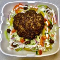 Chapli Kebab Over Salad  ·  One Patty ( beef patty made of seasoned onions, tomatoes, green chillies, eggs, spices, and...