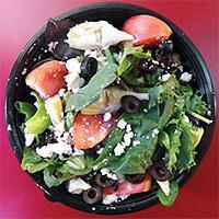 Greek Salad · Salad greens with artichoke hearts, black and green olives, tomatoes, feta cheese, and a you...