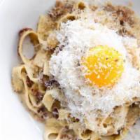 Truffle Carbonara Pasta · Fettuccine, cracked pepper, bacon, truffle cream, and egg yolk. All pasta made fresh at past...