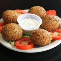 Falafel (5 pcs) (V) · Chickpea and fava beans ground with vegetables and spices. Served with tahini sauce, tomatoe...
