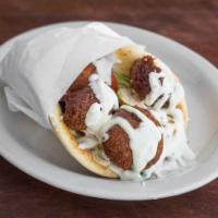 Falafel Gyro · Deep fried spiced chickpea patties served in grilled pita bread with lettuce, onions, pickle...