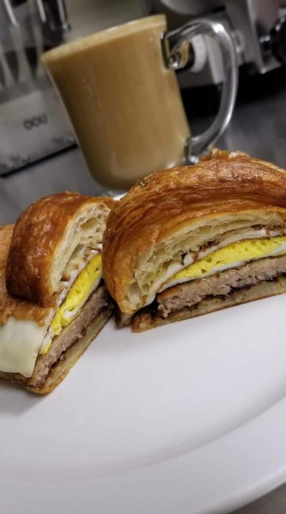 Breakfast Sandwich Combo · Over hard or scrambled egg, sausage, bacon with cheese on a bagel, English muffin or croissant. Served with juice.