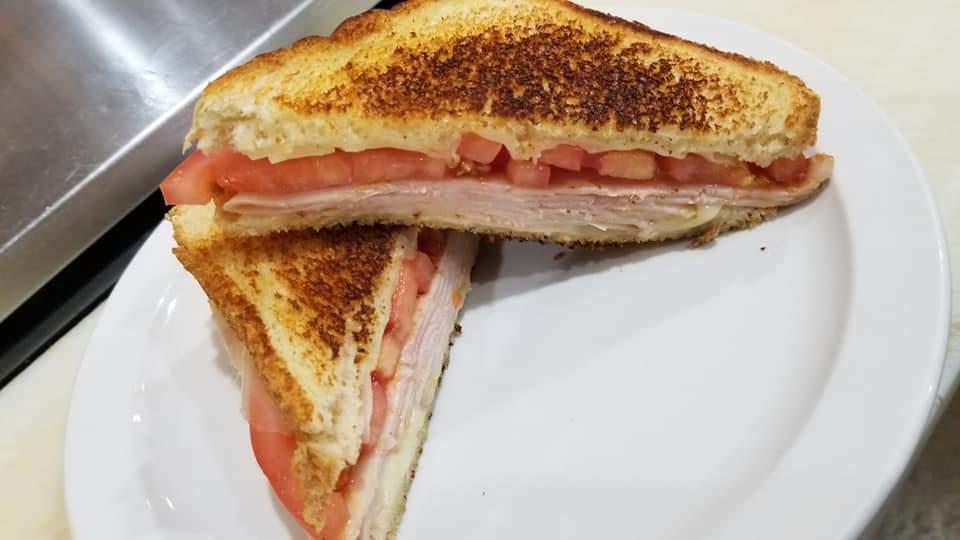 Grilled Melt Combo · Tuna, turkey or ham toasted with tomato and your choice of American, provolone or Swiss cheese. Served with bag of chips and a can of soda or bottled water.