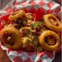 Lil Red · Scrambled eggs and sausage, onion rings, tater tots topped with some green onions and bacon ...