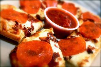 Ultimate North End Garlic Bread · Garlic bread topped with mozzarella, bacon, and pepperoni. Served with a side of marinara sauce.