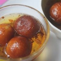 Gulab Jamun · Gulab Jamun is made of milk solids, flour and sugar and deep fried and served in a cardamon ...