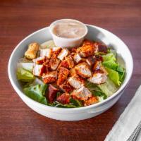 Cajun Chicken Caesar Salad · Includes romaine, parmesan cheese, croutons and cajun chicken. Served with Caesar Dressing.