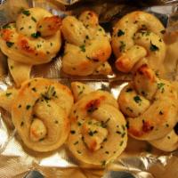Garlic Knots · Fresh made garlic knots with a fresh hose-made garlic herb oil infusion butter. Finished wit...