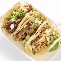 Al Pastor Street Tacos · 4 tacos. Marinated pork shoulder topped with cilantro, onions, lime and choice of sauce on c...