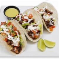 Pollo Tacos Rancheros · 4 tacos, marinated chicken topped with pico de gallo, sour cream, cotija cheese and lettuce ...
