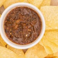 Chips & Salsa · House made fire roasted salsa served warm with chips.