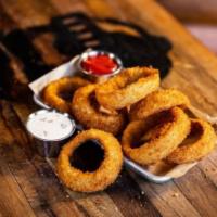 Onion Rings · Large onion rings, hand breaded to order, fry seasoning, bacon ranch and ketchup.