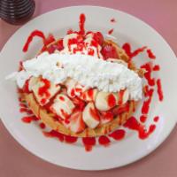 Alaskan Waffle Breakfast · Our house favorite topped with strawberries, bananas, ice cream and whipped cream.