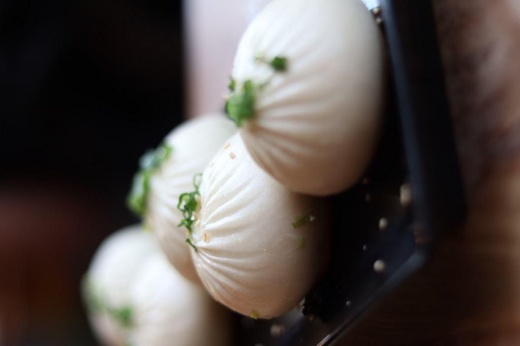 Q-Bao · Pan-fried berkshire-duroc pork buns. It is filled with moist pork, secret recipe aspic and wrapped with dough. After being half steamed and half pan-fried, buns turn out perfectly soft on the top, crispy and crunchy on the bottom.