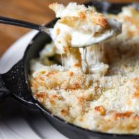 Cast Iron Mac and Cheese · 5 cheese blend tossed with penne pasta and baked with a Parmesan breadcrumb crust. Add bacon...